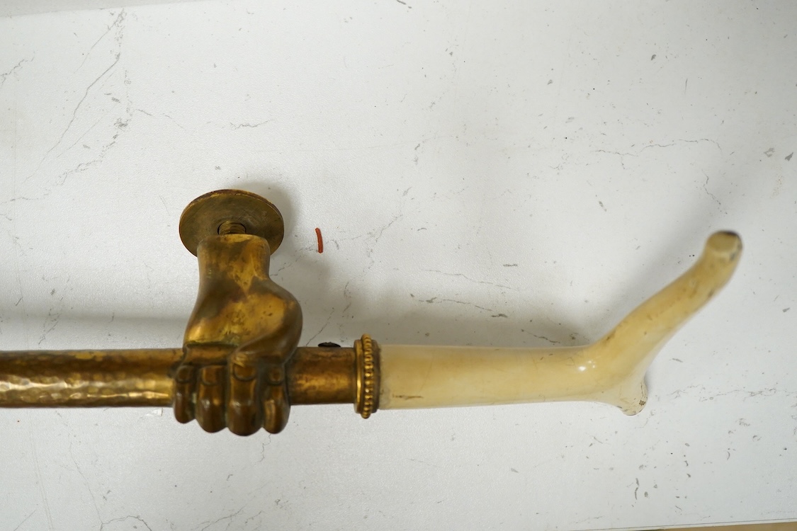 An unusual early 20th century gilt bronze or brass ‘riding crop and hand’ door handle, 65cm
